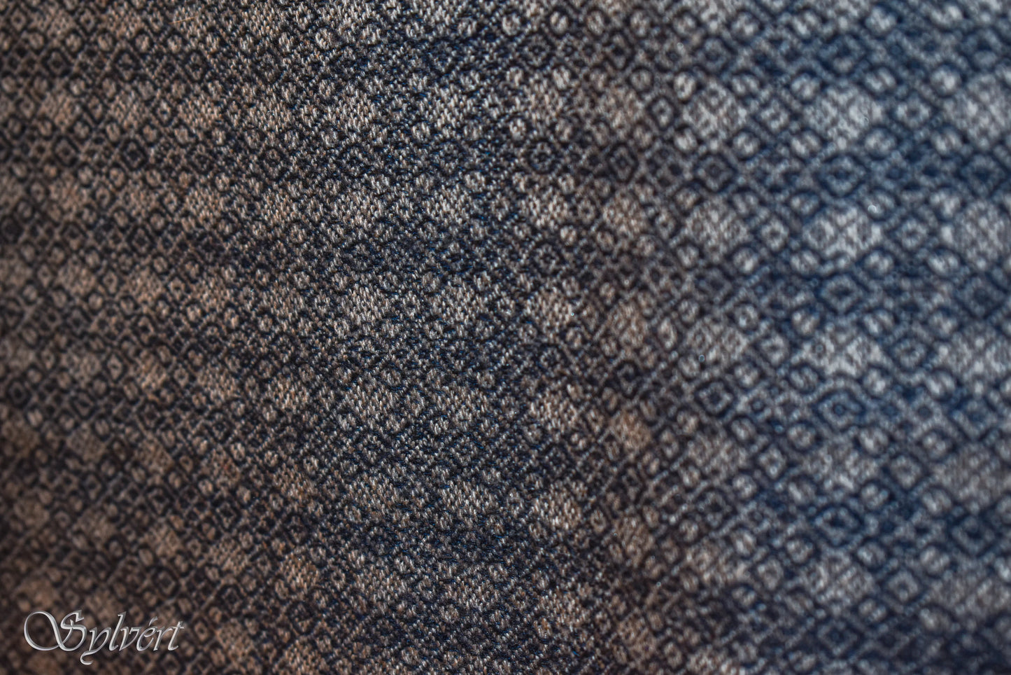 Close-up of blue and beige woven fabric with diamond pattern texture