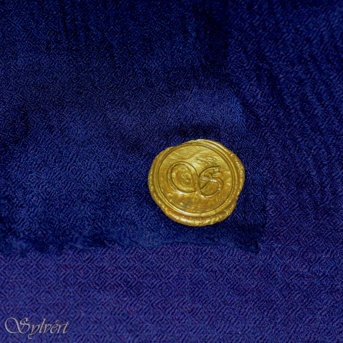 A blue Corvella Norien from Sylvért's Coronis collection, folded to show the diamond weave texture and gold Sylvért stamp
