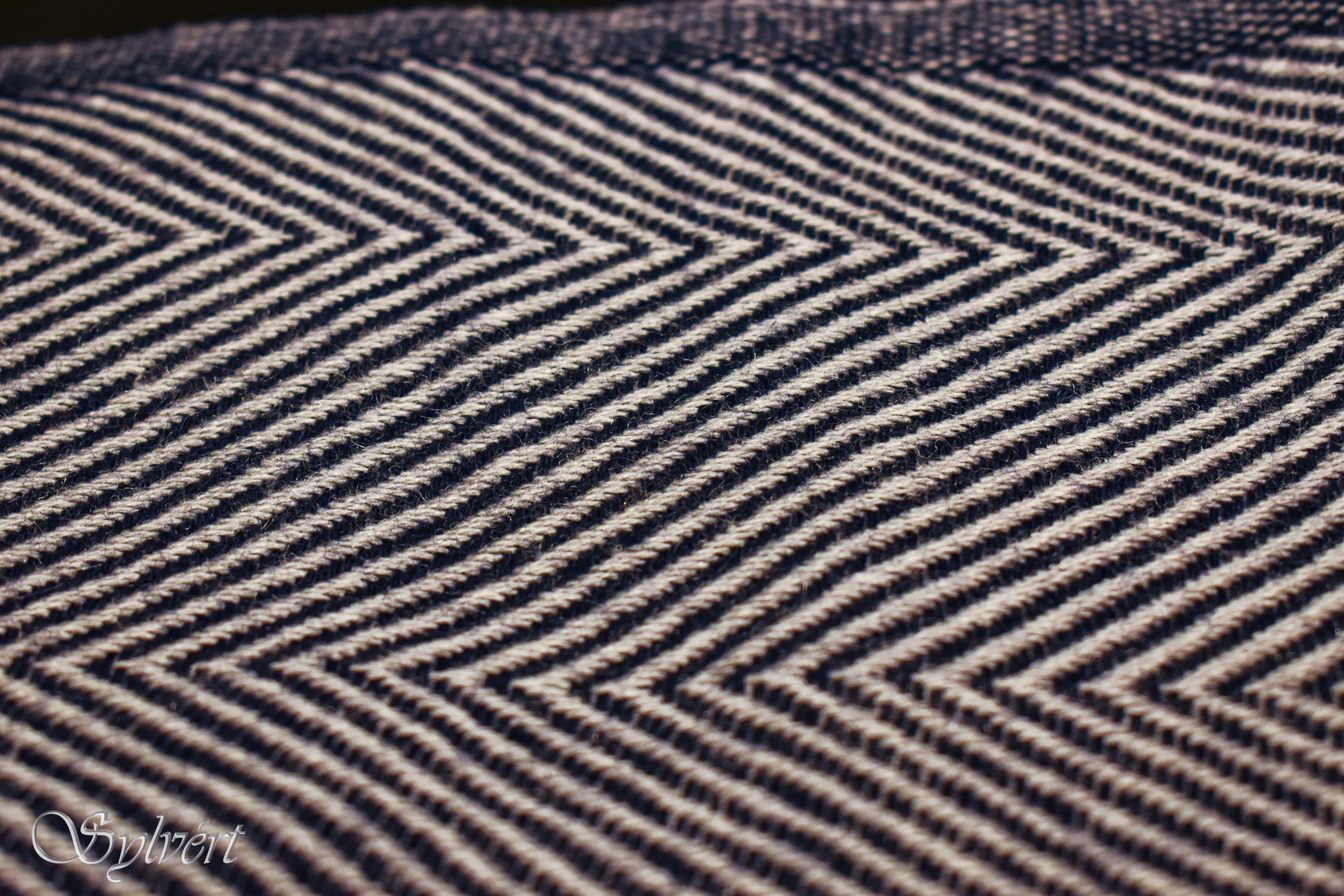 Close-up of black and white chevron herringbone fabric texture with Sylvert watermark