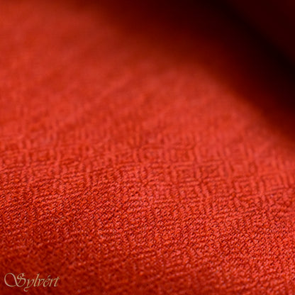 A red cashmere Rivella Sirel Scarf from Sylvért's Rivanor Collection, folded to show the diamond weave texture.
