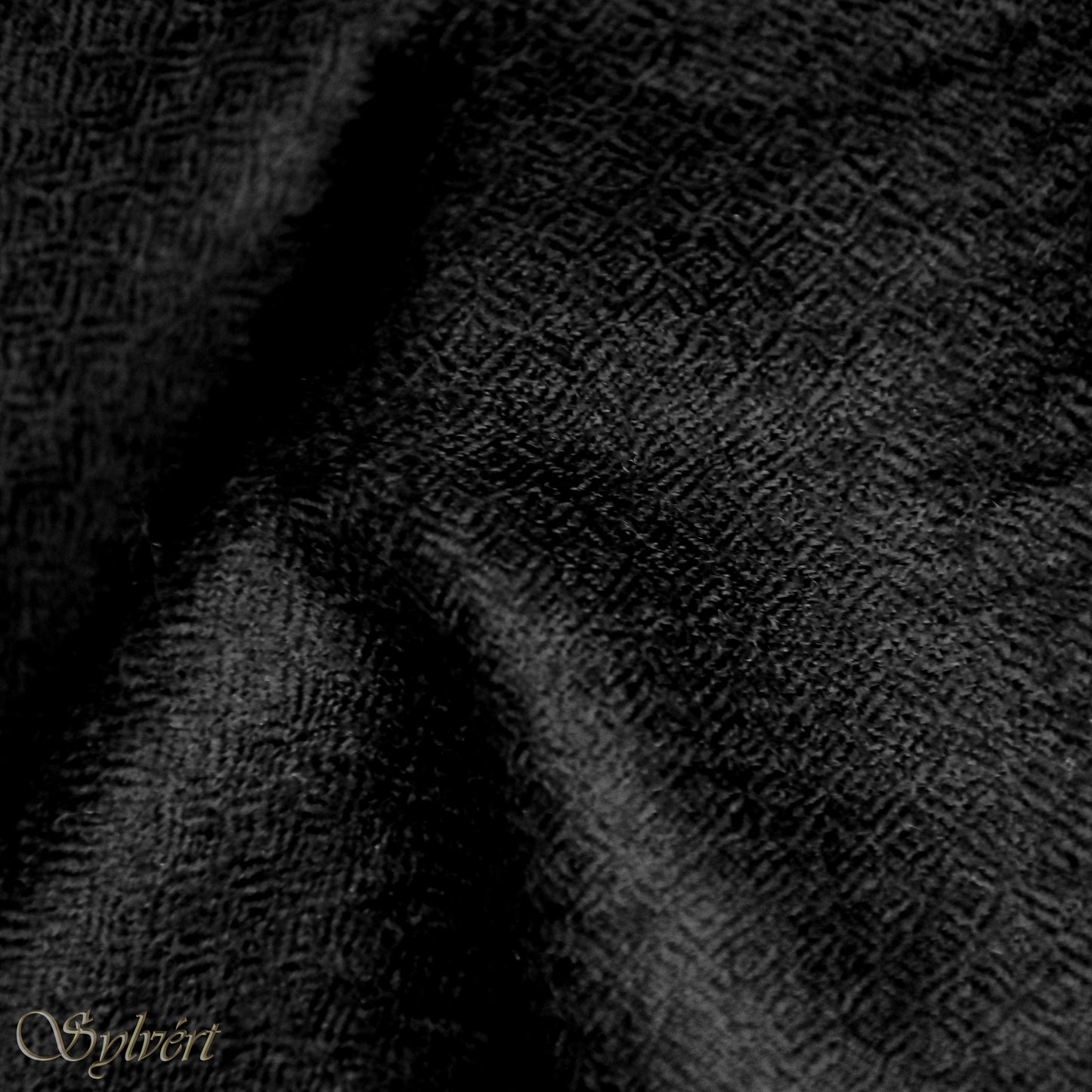 A black Corvella Noctra from Sylvért's Coronis collection, folded to show the diamond weave texture 