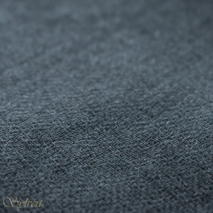 A blue-grey slate cashmere Rivella Veyra Scarf from Sylvért's Rivanor Collection, folded to show the diamond weave texture 