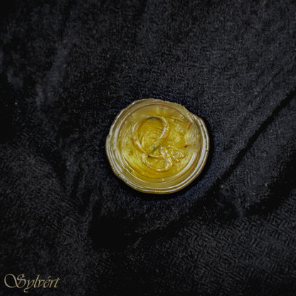 A black Corvella Noctra from Sylvért's Coronis collection, folded to show the diamond weave texture  and gold Sylvért stamp