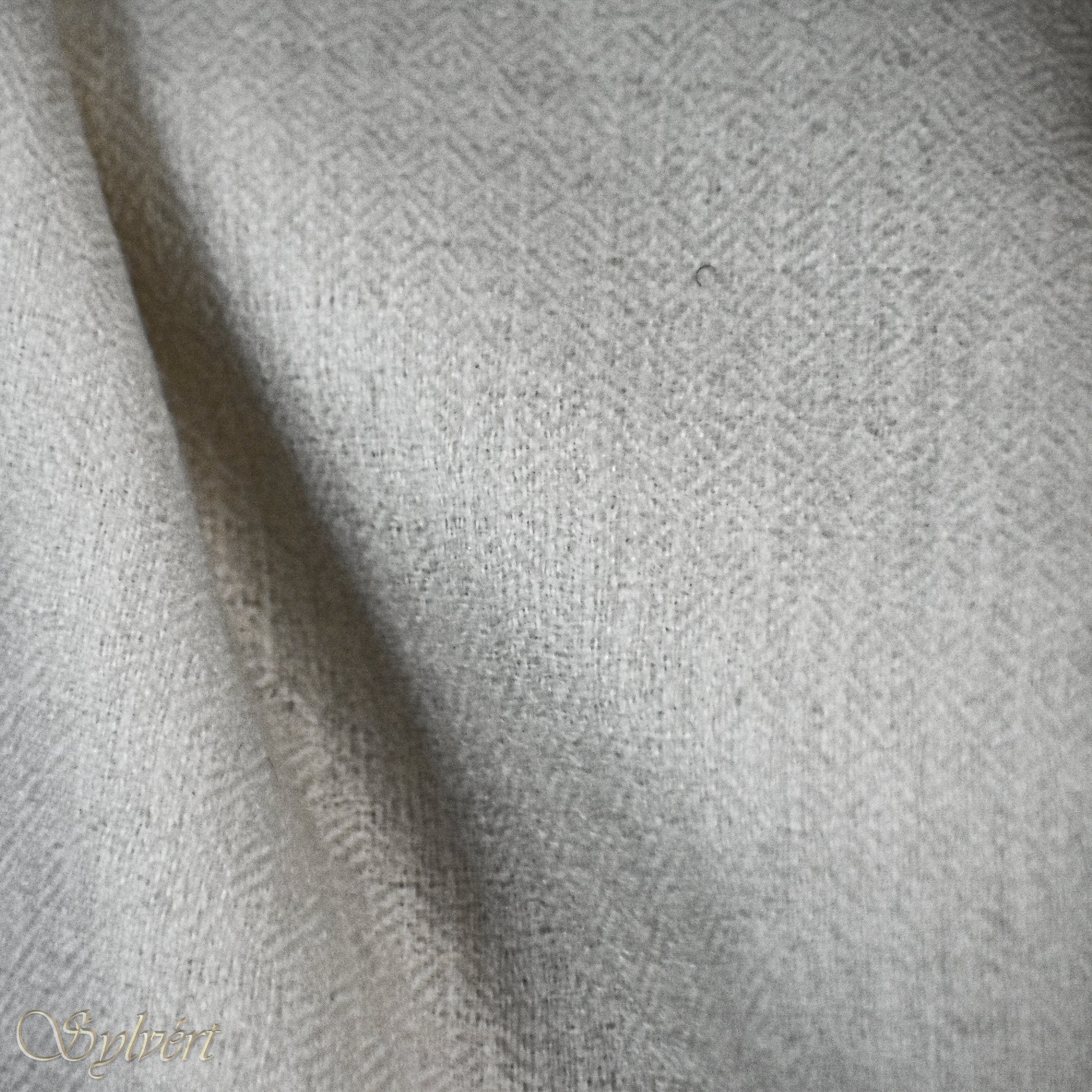 A white Corvella Orlien from Sylvért's Coronis collection, folded to show the diamond weave texture 