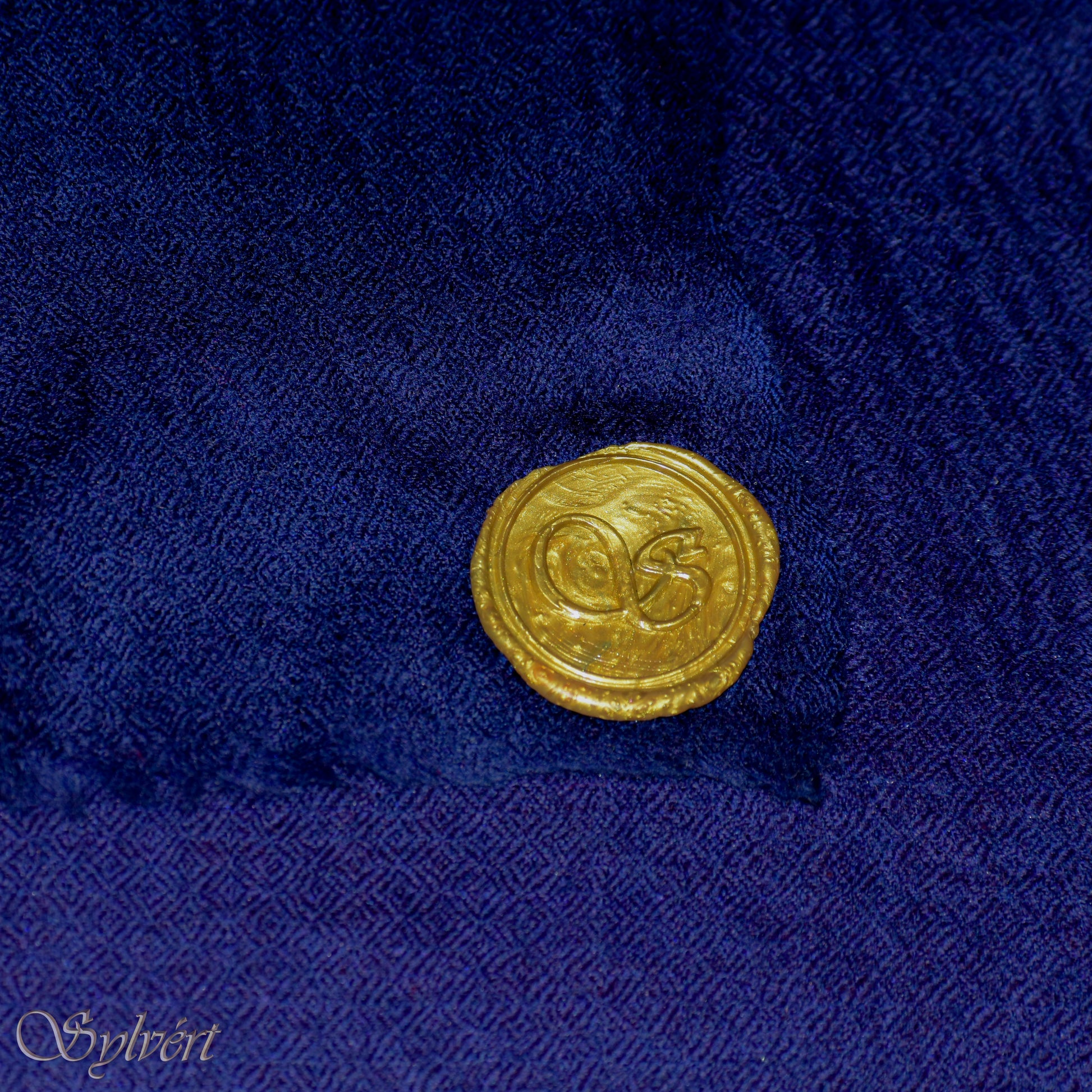 A blue Corvella Norien from Sylvért's Coronis collection, folded to show the diamond weave texture  and gold Sylvért stamp