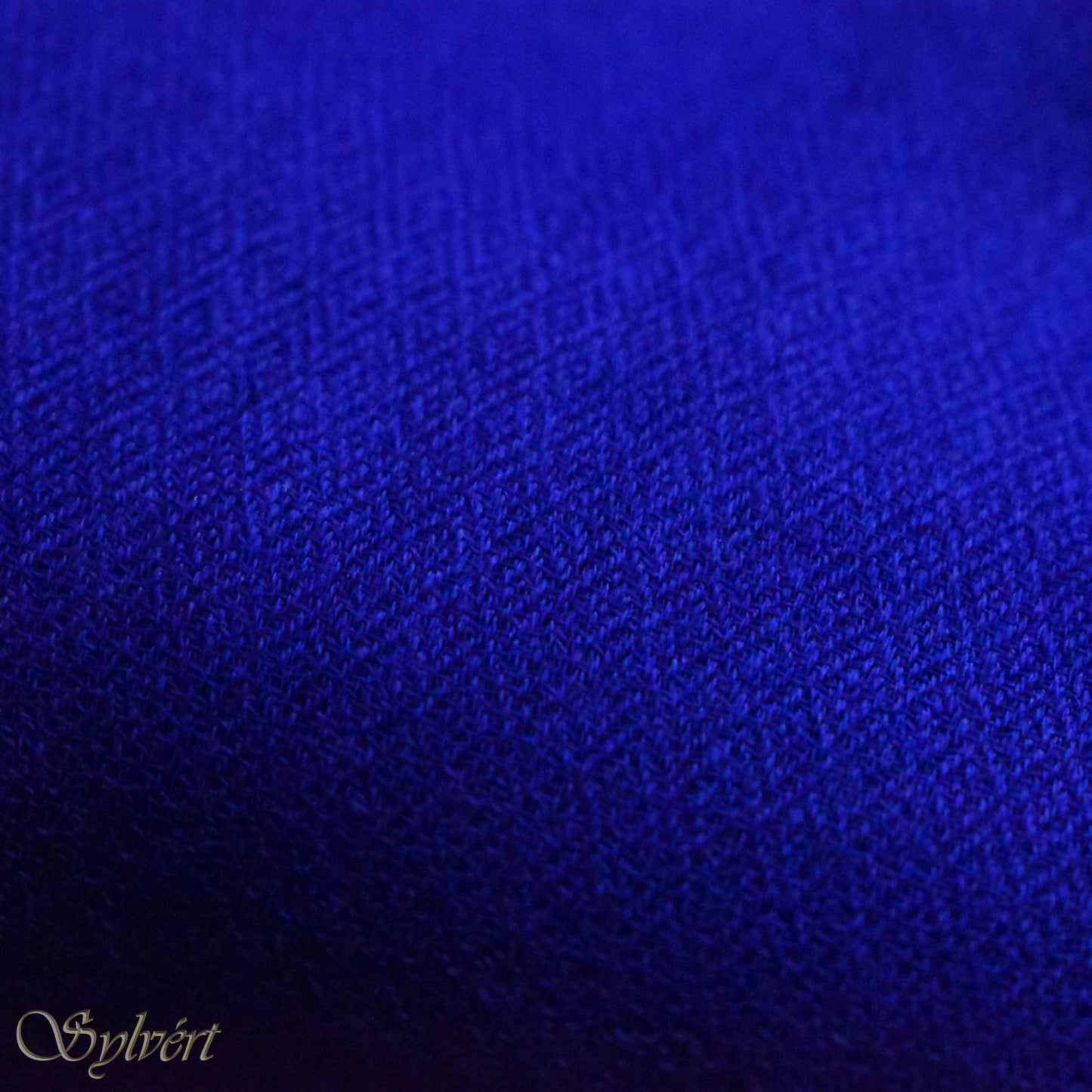 A blue cashmere Rivella Orven Scarf from Sylvért's Rivanor Collection, folded to show the diamond weave texture 
