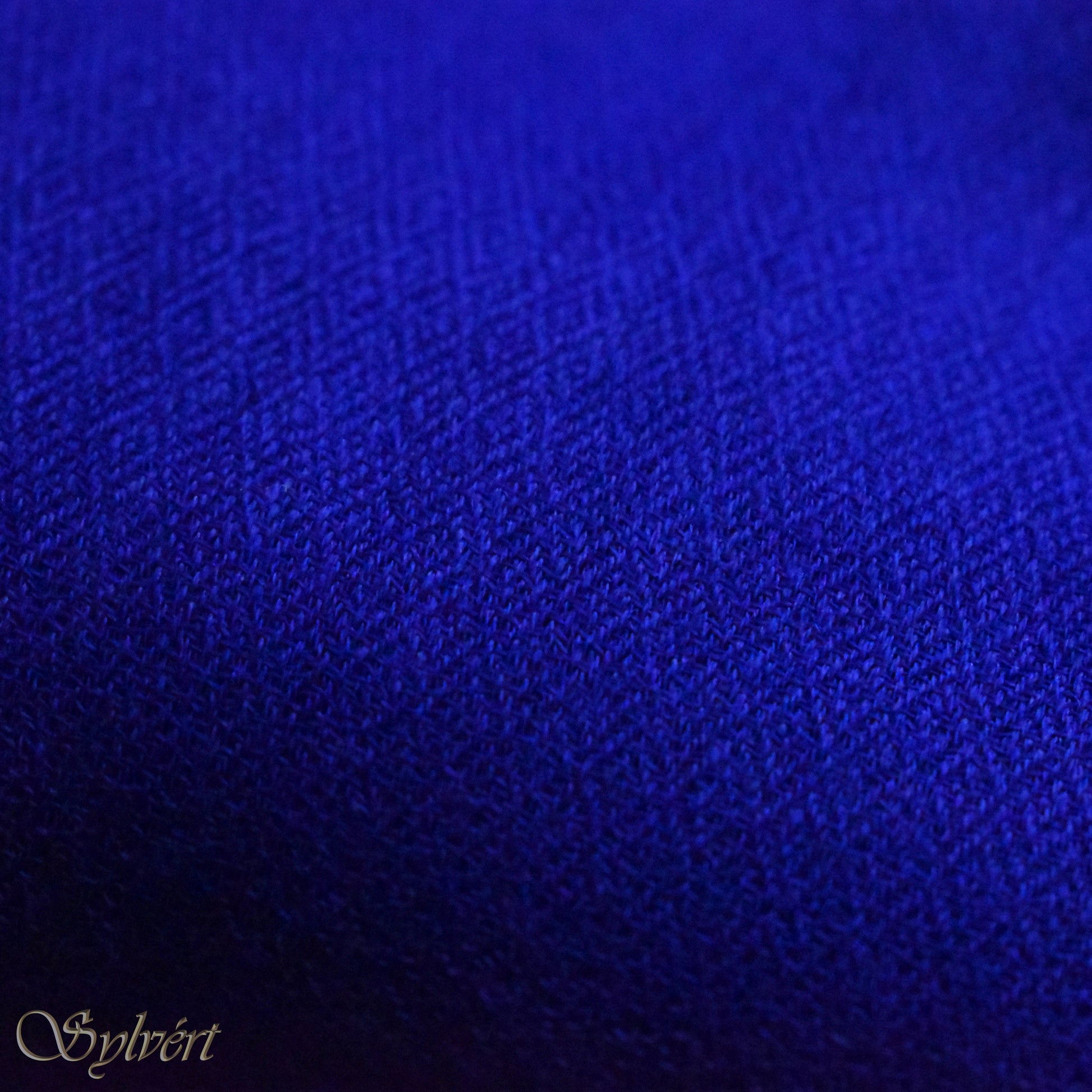 A blue cashmere Rivella Orven Scarf from Sylvért's Rivanor Collection, folded to show the diamond weave texture 