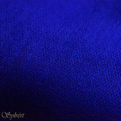 A blue cashmere Rivella Orven Scarf from Sylvért's Rivanor Collection, folded to show the diamond weave texture 