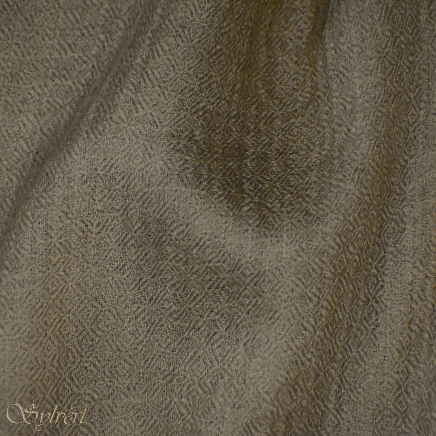A beige Corvella Draván from Sylvért's Coronis collection, folded to show the diamond weave texture 