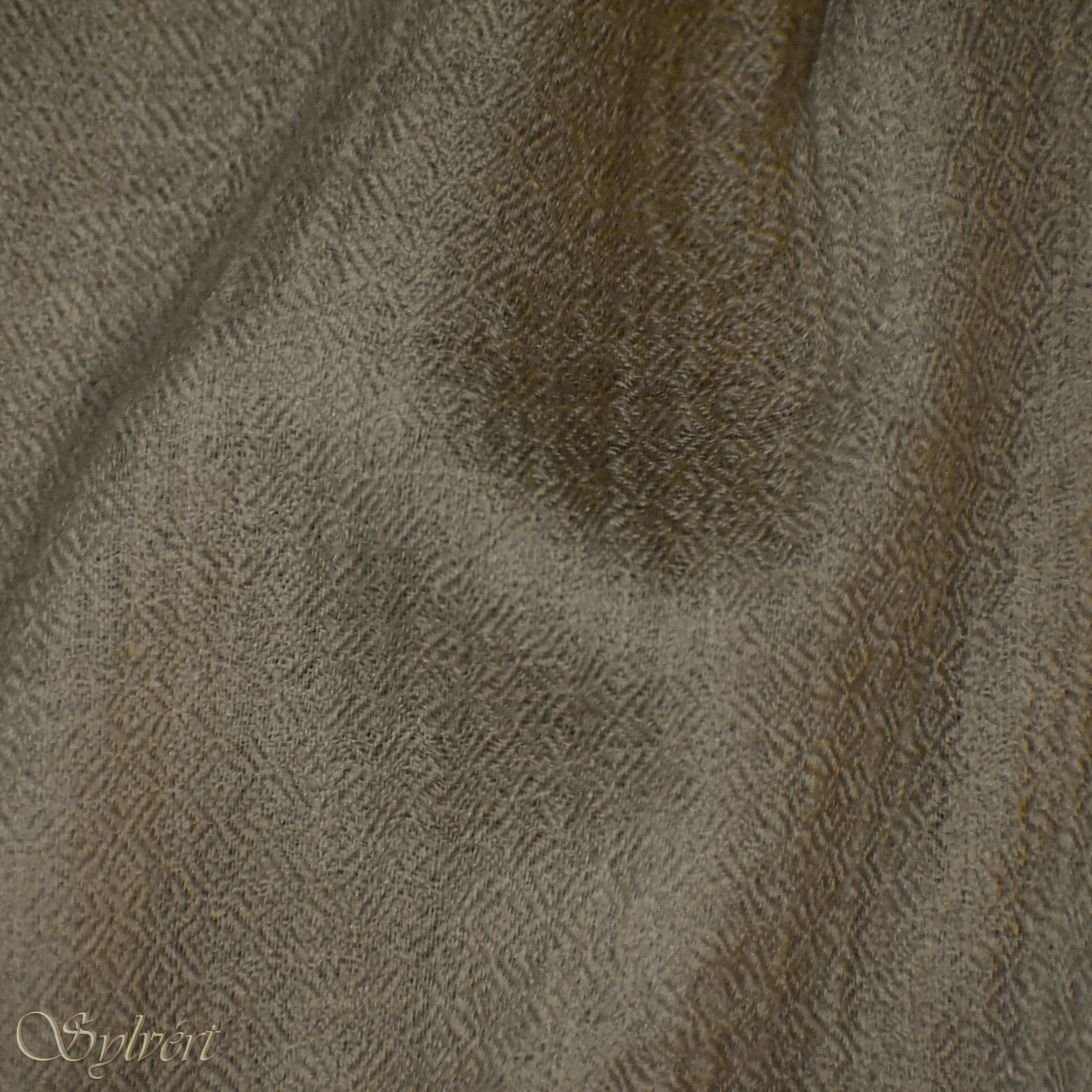 A beige Corvella Draván from Sylvért's Coronis collection, folded to show the diamond weave texture 